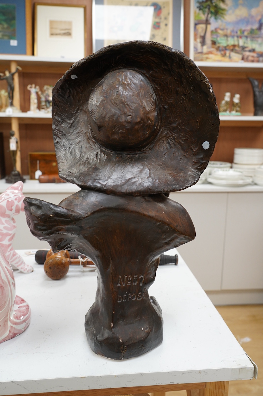 A 20th century French bronzed plaster bust of a lady ‘Coquette’, 52cm. Condition - fair, some losses to bronzing